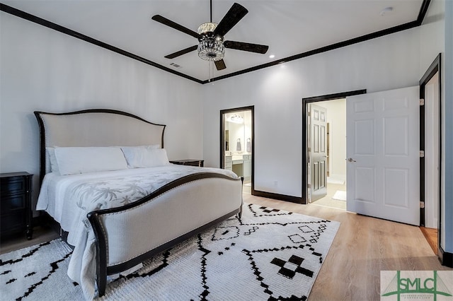 bedroom with ornamental molding, baseboards, light wood finished floors, and ensuite bathroom