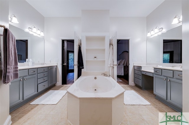 ensuite bathroom featuring tile patterned flooring, two vanities, and ensuite bathroom