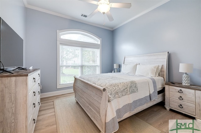 bedroom with ornamental molding, light wood-style flooring, visible vents, and baseboards