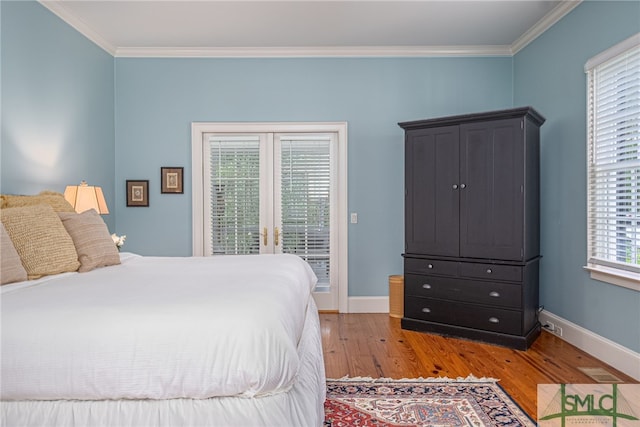 bedroom with access to outside, crown molding, and hardwood / wood-style floors