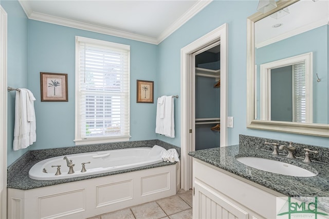 bathroom featuring ornamental molding, a wealth of natural light, a washtub, and vanity