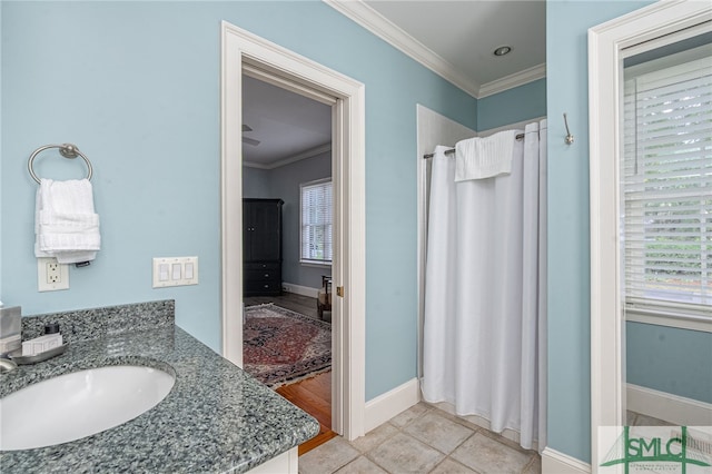 bathroom featuring vanity, tile patterned flooring, and ornamental molding