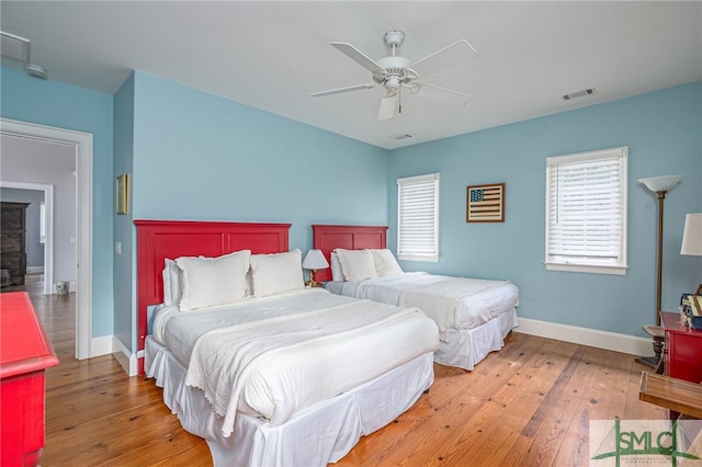 bedroom with wood-type flooring and ceiling fan