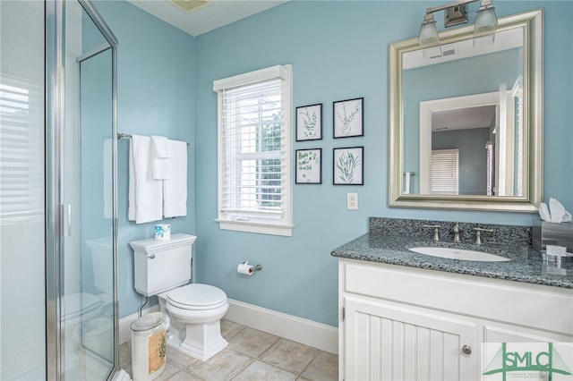 bathroom featuring vanity, toilet, a shower with door, and tile patterned floors