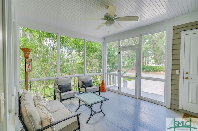 sunroom / solarium featuring ceiling fan