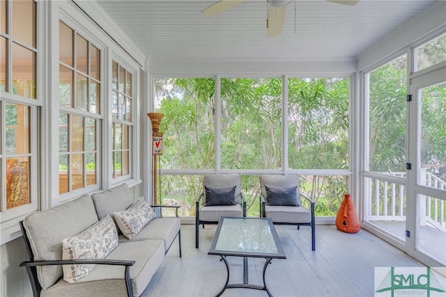 sunroom / solarium featuring ceiling fan