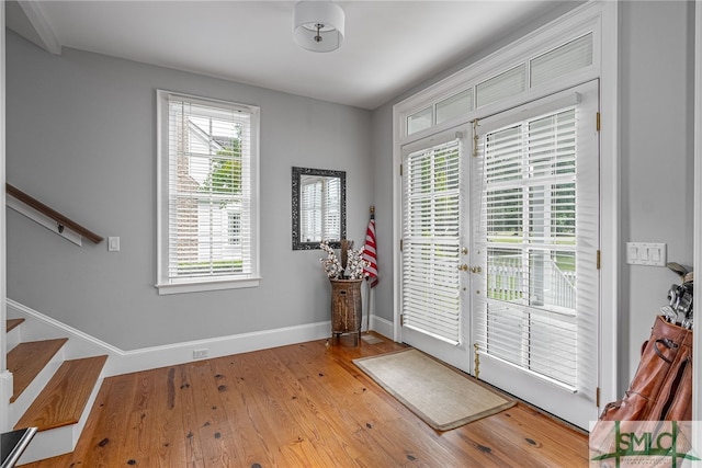 doorway to outside with wood-type flooring