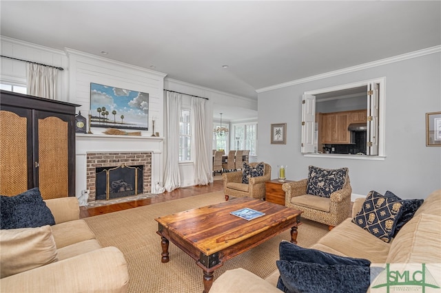 living room with hardwood / wood-style flooring, a fireplace, and crown molding