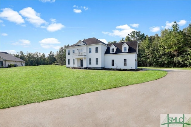 173 Trail Rd S, Midway, GA 31320 - colonial house featuring driveway, a balcony, and a front lawn