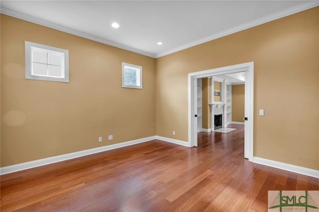 unfurnished room featuring wood-type flooring and ornamental molding