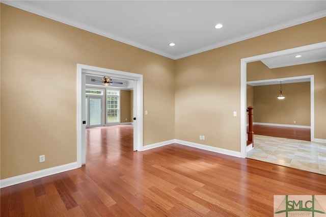 unfurnished room with wood-type flooring, ornamental molding, and ceiling fan