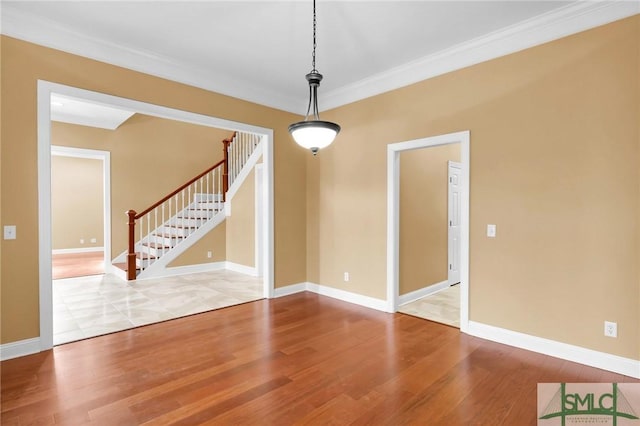 173 Trail Rd S, Midway, GA 31320 - empty room with crown molding, wood finished floors, baseboards, and stairs