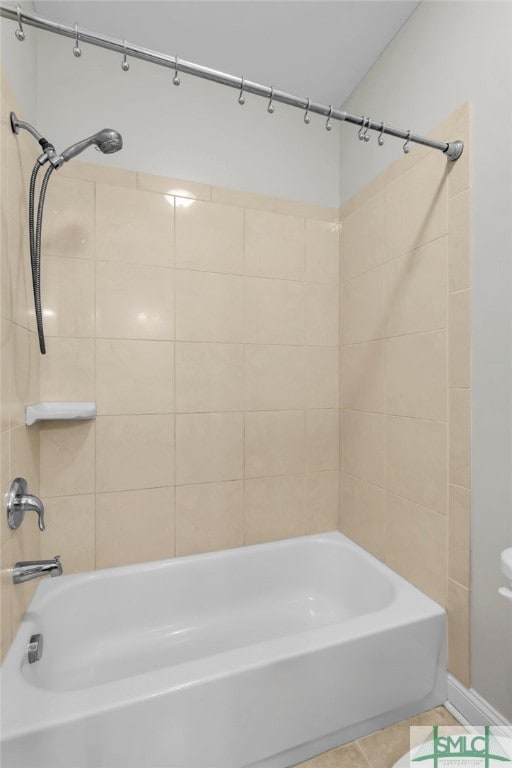 bathroom with tile patterned flooring and tiled shower / bath