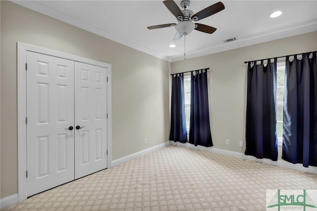 unfurnished bedroom with light carpet, multiple windows, ceiling fan, and crown molding