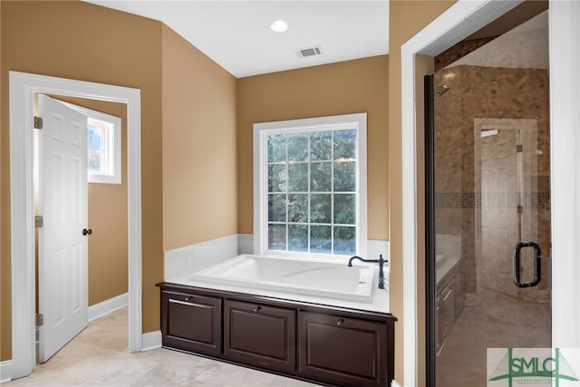 bathroom featuring shower with separate bathtub, tile patterned floors, and plenty of natural light