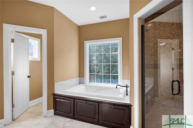 173 Trail Rd S, Midway, GA 31320 - full bath featuring visible vents, a bath, a shower stall, and baseboards
