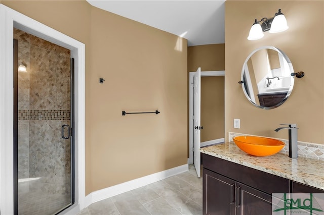 bathroom featuring tile patterned floors, a shower with door, and vanity