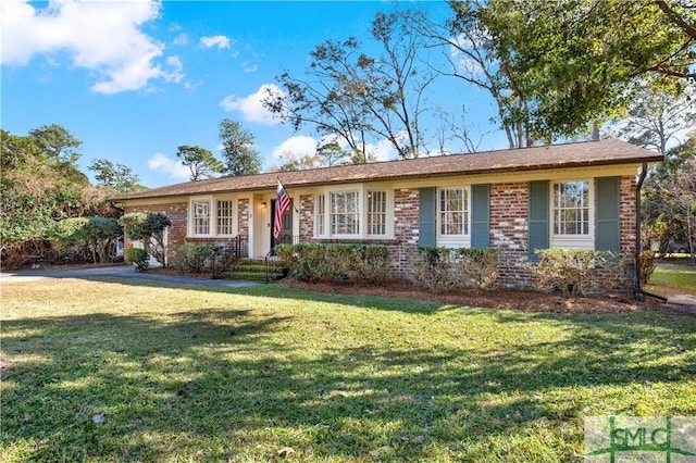 ranch-style house with brick siding and a front yard