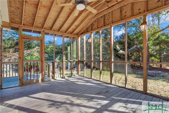 unfurnished sunroom featuring lofted ceiling and ceiling fan