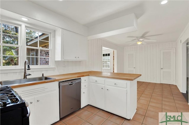 kitchen with light tile patterned floors, sink, dishwasher, white cabinets, and kitchen peninsula