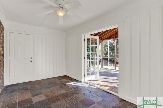 entryway with stone tile floors and ceiling fan