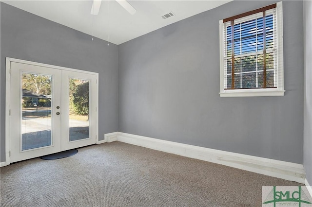 spare room featuring a healthy amount of sunlight, visible vents, french doors, and carpet flooring