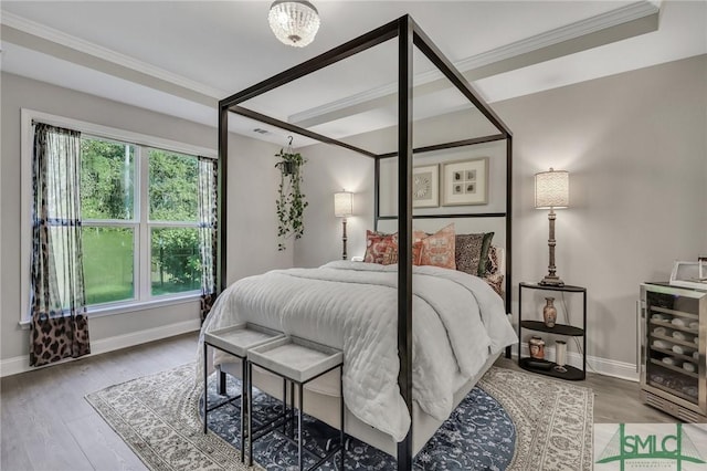 bedroom with wood-type flooring and crown molding