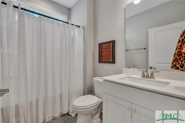 bathroom with vanity, toilet, and walk in shower