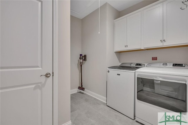 laundry area with cabinets and washer and clothes dryer