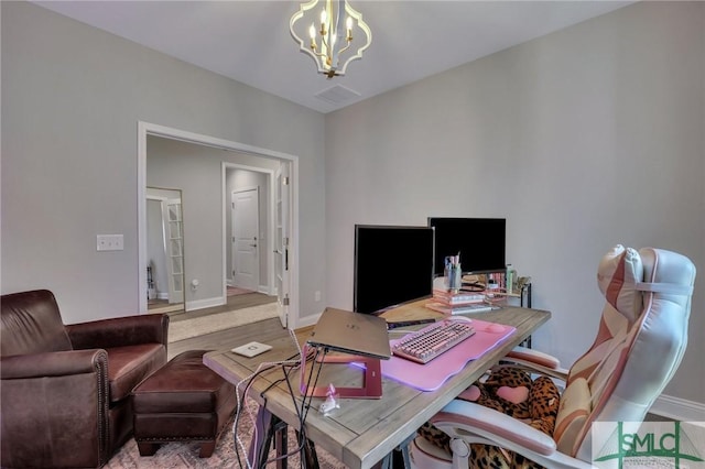 home office featuring hardwood / wood-style flooring and a notable chandelier