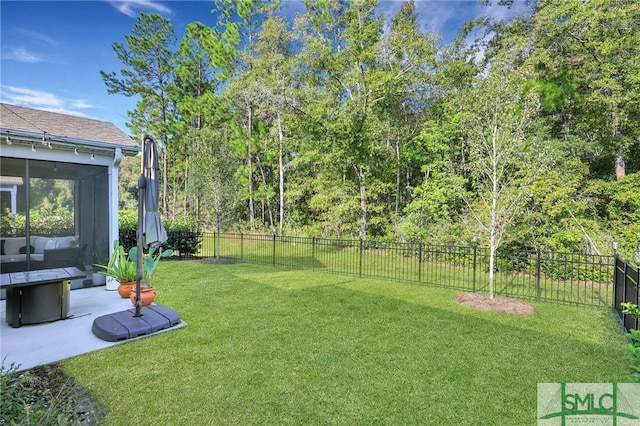 view of yard featuring a sunroom and a patio