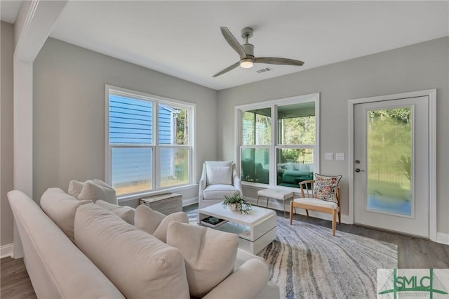 living room with hardwood / wood-style flooring and ceiling fan