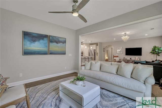 living room with hardwood / wood-style flooring and ceiling fan