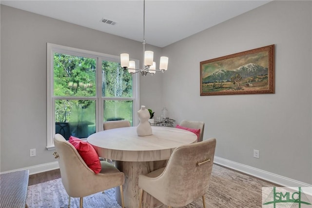 dining room featuring hardwood / wood-style floors and a chandelier