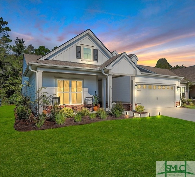 craftsman-style house with a garage, a yard, and covered porch