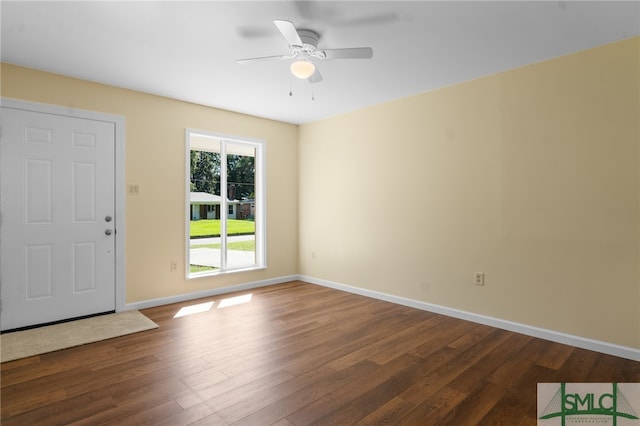 unfurnished room with ceiling fan and dark wood-type flooring