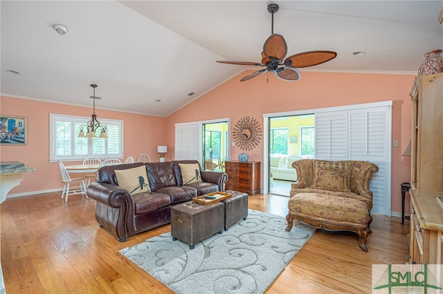 living room featuring ceiling fan with notable chandelier, light hardwood / wood-style flooring, plenty of natural light, and crown molding