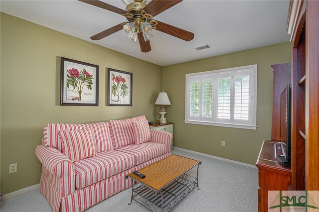 carpeted living room with ceiling fan