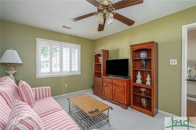 carpeted living room featuring ceiling fan