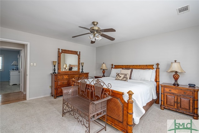 bedroom with light carpet and ceiling fan