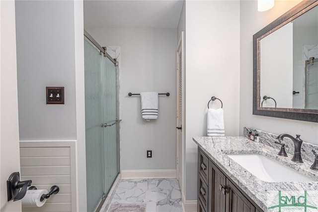 bathroom with vanity and a shower with shower door