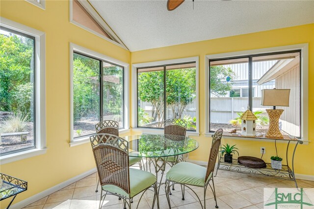 sunroom / solarium featuring vaulted ceiling and a healthy amount of sunlight