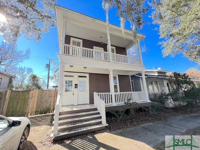 view of front of property with a balcony and covered porch