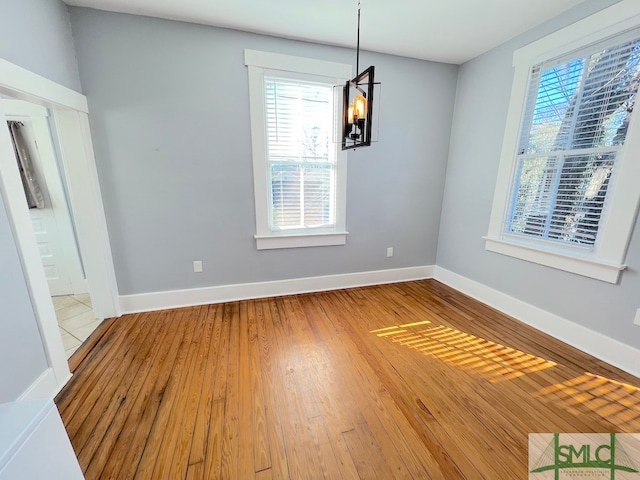 interior space featuring wood-type flooring and an inviting chandelier