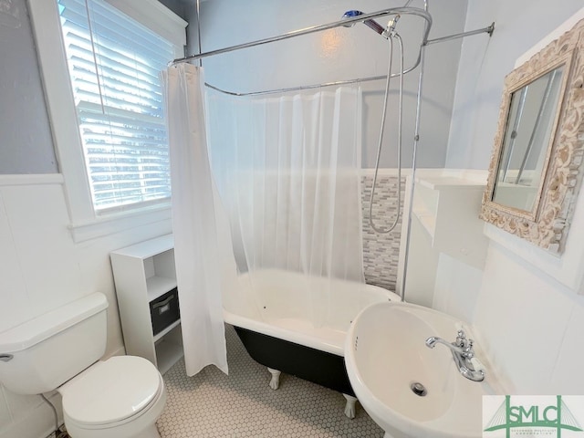 bathroom with shower / bath combo with shower curtain, toilet, and tile patterned flooring