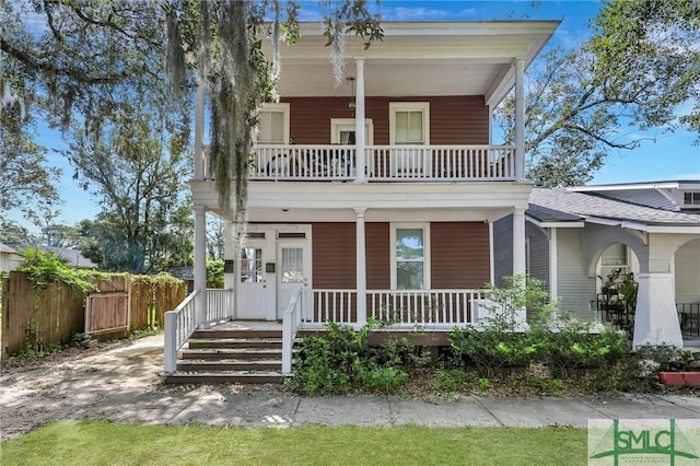 view of front of property featuring a balcony and a porch