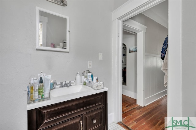 bathroom featuring vanity, crown molding, and hardwood / wood-style floors