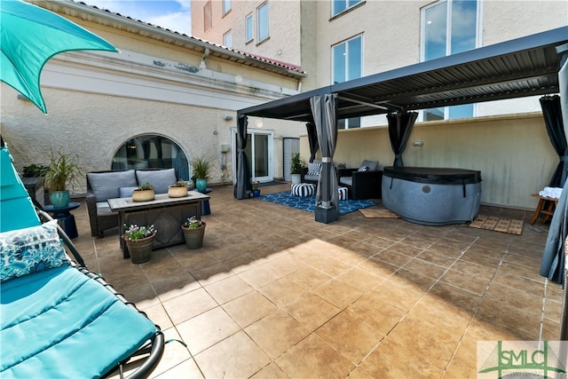 view of patio featuring an outdoor living space and a hot tub