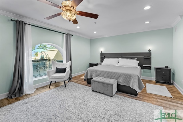 bedroom with ornamental molding, ceiling fan, and hardwood / wood-style flooring