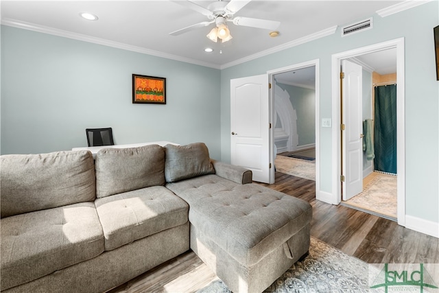 living room featuring wood-type flooring, crown molding, and ceiling fan